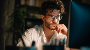 A determined young professional learner in his office