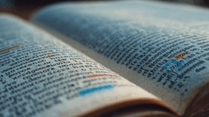 A close-up of a grammar book with a red correction mark
