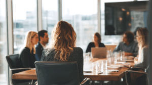 A group of colleagues sitting around a conference table, preparing for an important meeting the next day.
