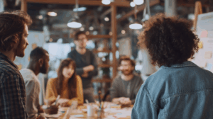 A group of entrepreneurs brainstorming ideas around a table, one of them presenting a new business plan.
