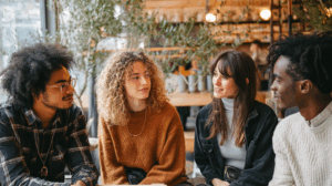 A group of friends sitting together in a café, discussing their plans