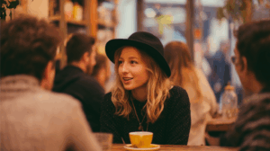 A person chatting with friends at a coffee shop