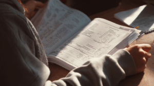 A person looking at a grammar workbook
