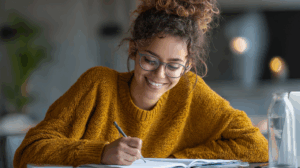 A person practicing their future plans by writing in a journal