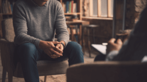 A person sitting across from a friend, discussing their future plans