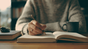 A person sitting at a desk with an open notebook