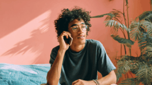 A person telling a friend over the phone about their weekend plans