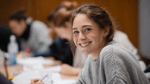 A student smiling with confidence after completing a grammar exercise