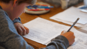 A student confidently writing in their notebook