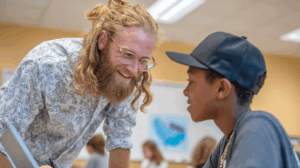 A teacher asking a student about their assignment