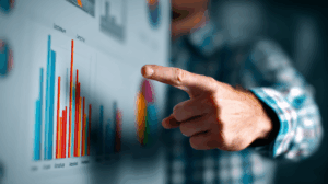 A teacher pointing to a chart