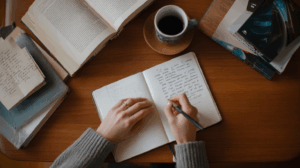 A writer sitting at a desk with a notebook