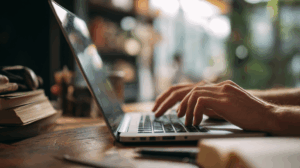 A writer typing a story on a laptop