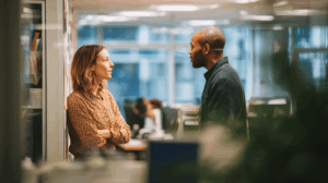 Two people practicing a role-play in an office setting