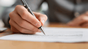 A person reworking their sentence on paper