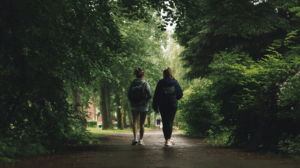 Two friends are walking in a park
