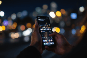 a person holding a smartphone late at night, endlessly scrolling through social media feeds