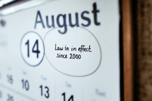 A calendar marking a date with the text “Law in effect since 2000,” 