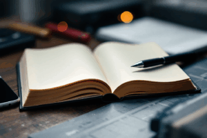 an open english notebook on top of a desk