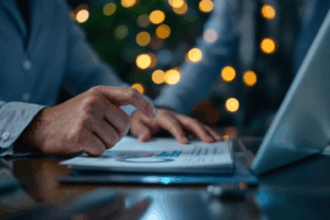 A business professional reviewing a business report on a laptop
