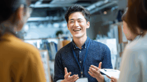 a japanese man who is young adult talking to his co-workers