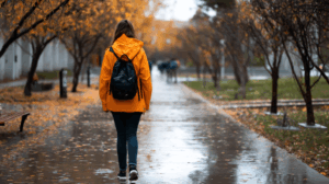 a woman college student walking to school
